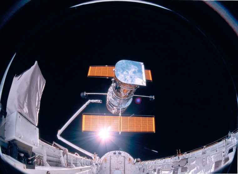 This photograph was taken by the STS-31 crew aboard the Space Shuttle Discovery and shows the Hubble Space Telescope being deployed on 04/25/90 from the payload bay.
