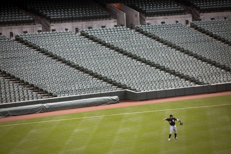 White Sox outfielder Avisail Garcia throws a ball back to the pitcher during the MLB game at an empty Camden Yards stadium in Baltimore, Md., on April 29, 2015. (Photo by John Taggart/EPA)