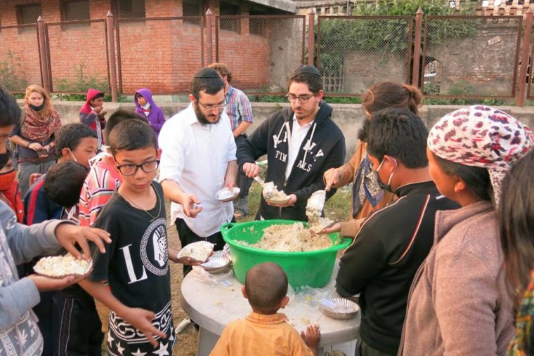 A group of volunteers with Chabad-Lubavitch of Nepal distribute hot food to hundreds of hungry Nepalese citizens on Wednesday, April 29 in Kathmandu, Nepal. (Photo by Chabad.org/Chabad of Nepal)