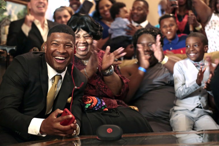 Jameis Winston reacts with his family and friends as he takes the call from the Tampa Bay Buccaneers that they are selecting him as the number one draft pick, April 30, 2015, in Bessemer, Ala. (Photo by Butch Dill/AP)
