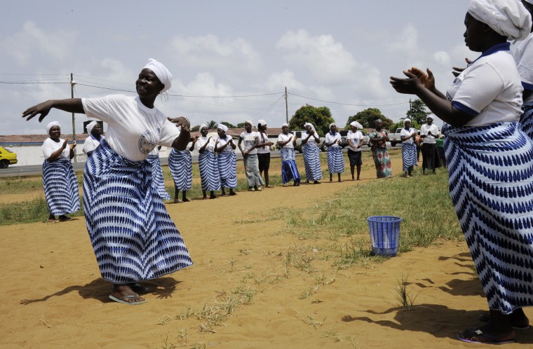 Members of the Women In Peace building Network dance and pray on May 8, 2015 in Monrovia. The World Health Organization (WHO) has declared Liberia \"Ebola-free.\" (Photo by Zoom Dosso/AFP/Getty)