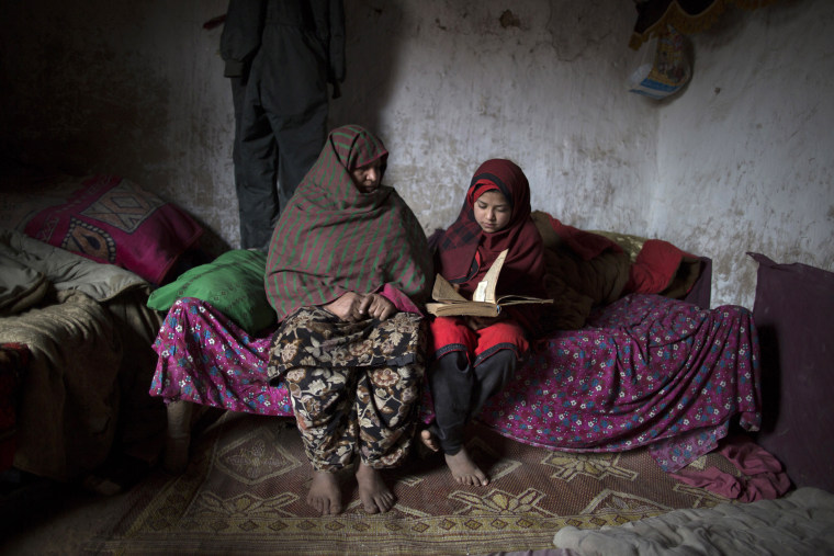 Tadjroshan, 40, poses for a photograph with her daughter Ayman, 12, at their house in a slum on the outskirts of Islamabad February 4, 2014. (Photo by Zohra Bensemra/Reuters)