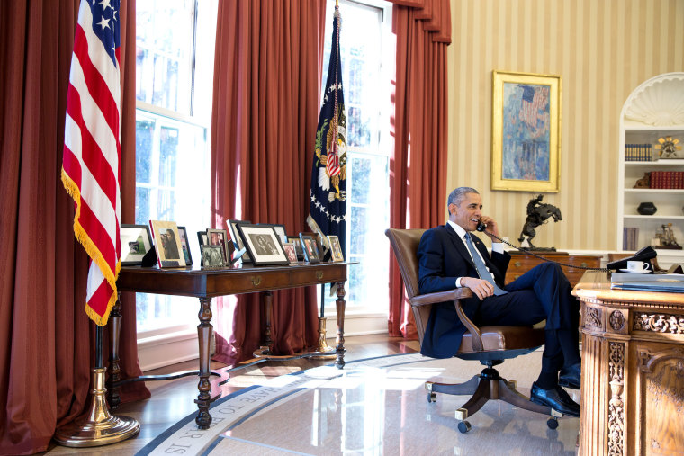 President Barack Obama talks on the phone with Alan Gross, who was en route to the United States from Cuba, in the Oval Office in this Dec. 17, 2014 White House handout photo. (Photo by Pete Souza/White House/Handout/Reuters)