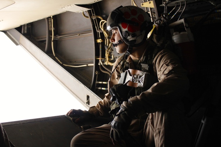 U.S. Marine David Dequeljoe looks out from a Boeing V-22 Osprey delivering aid supplies in Nepal.
