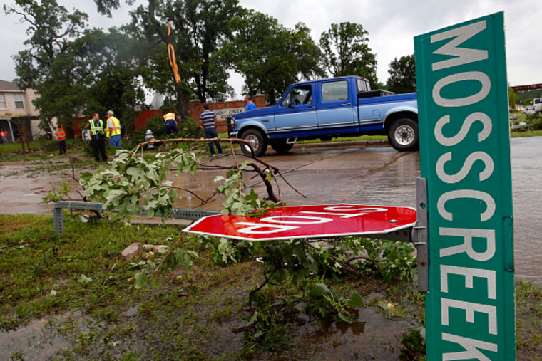 A street sign at the intersection of Hwy 377 and Mosscreek Drive lies on the ground after a possible tornado touched down in the Bent Creek Estates neighborhood in Denton, Texas, on May 10, 2015. (Richard W. Rodriguez/Fort Worth Star-Telegram/TNS/Getty)