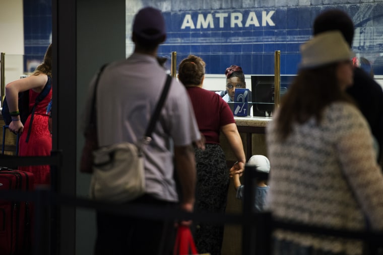 Travelers stand in line for tickets and information at the Amtrak desk at Union Station in Washington, DC on May 13, 2015. (Photo by Shawn Thew/EPA)