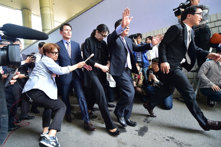 Former Korean Air (KAL) executive Cho Hyun-Ah (C) leaves after she received a suspended jail sentence and was freed by a Seoul appeals court in Seoul on May 22, 2015. (Photo by Jung Yeon-Je/AFP/Getty)