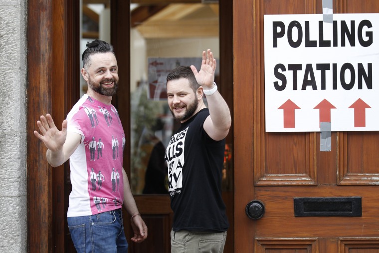 Partners Adrian, left and Shane, arrive to vote at a polling station in Drogheda, Ireland, Friday, May 22, 2015. (Photo by Peter Morrison/AP)