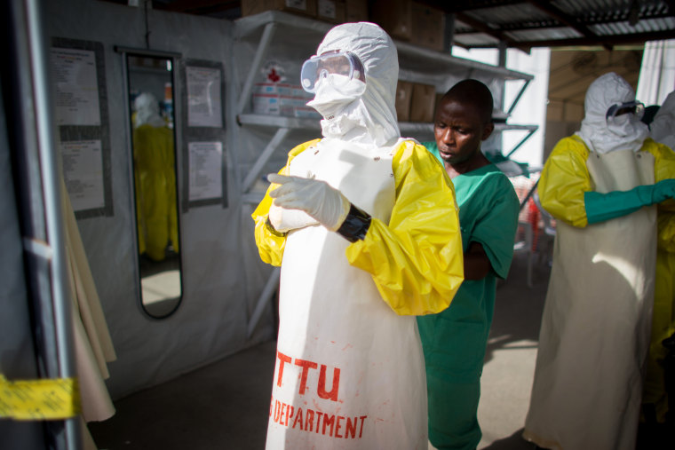 Volunteer Ebola helpers in protective suits prepare for a demonstration of their work at the SITTU (Severe Infections Temporary Treatment Unit) in Monrovia, Liberia, on April 9, 2015. (Photo by Kay Nietfeld/Picture Alliance/DPA/AP)