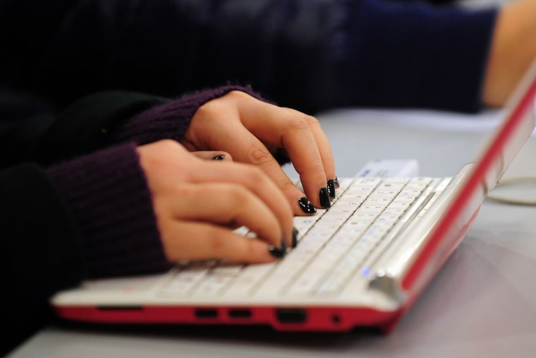 A woman types on her laptop. (Photo by Frederic J. Brown/AFP/Getty)