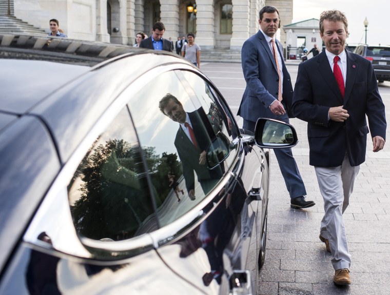 Sen. Rand Paul and Rep. Justin Amash leave the U.S. Capitol in Rep. Thomas Massie's Tesla after Sen. Paul spoke at length on the Senate floor against an extension of provisions of the Patriot Act, May 31, 2015. (Photo By Bill Clark/CQ Roll Call/Getty)