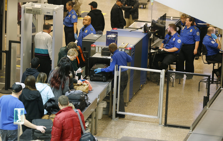 Passengers make their way through a Transportation Security Administration (TSA) check point at Salt Lake City International Airport in Salt Lake City, Utah, Dec. 23, 2014. (Photo by George Frey/Bloomberg/Getty)