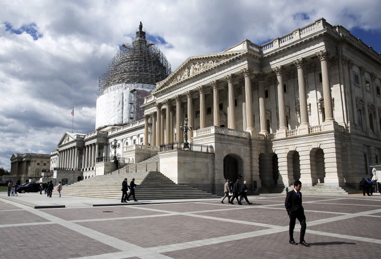 A man walks in front of the U.S. Capitol in Washington April 23, 2015. (Photo by Joshua Roberts/Reuters)