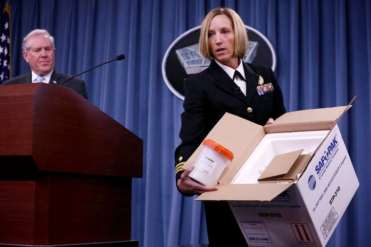 Director of Medical Programs for DoD Chemical and Biological Defense Cdr. Franca Jones demonstrate protocol for shipping anthrax samples during a news briefing on the Anthrax shipment investigation, June 3, 2015 at the Pentagon. (Photo by Alex Wong/Getty)