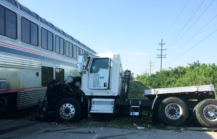 A train is stopped following a train collision near Wilmington, Ill., June 5, 2015. The Amtrak train was headed to Chicago from San Antonio and slammed into a semitrailer at a crossing. (Photo by Sam Herwitz/AP)