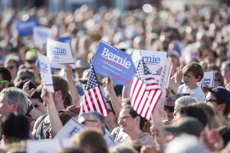 Supporters hold up signs and U.S. flags during the official kickoff to Senator Bernie Sanders' presidential campaign in Burlington, Vt. on May 26, 2015. (Photo by Scott Eisen/Bloomberg/Getty)