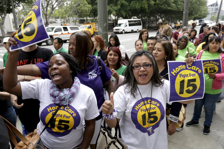 People demonstrate outside City Hall before the Los Angeles City Council approved a proposal to raise the minimum wage to $15.00 per hour in Los Angeles, Calif., June 3, 2015. (Photo by Jonathan Alcorn/Reuters)
