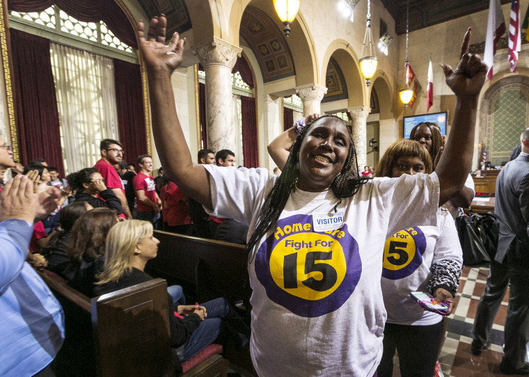 Workers react as the Los Angeles City Council votes 13-1 to raise the minimum wage to $15 an hour by 2020, but a second vote is required for final approval because the tally was not unanimous, in Los Angeles, June 3, 2015. (Photo by Damian Dovarganes/AP)