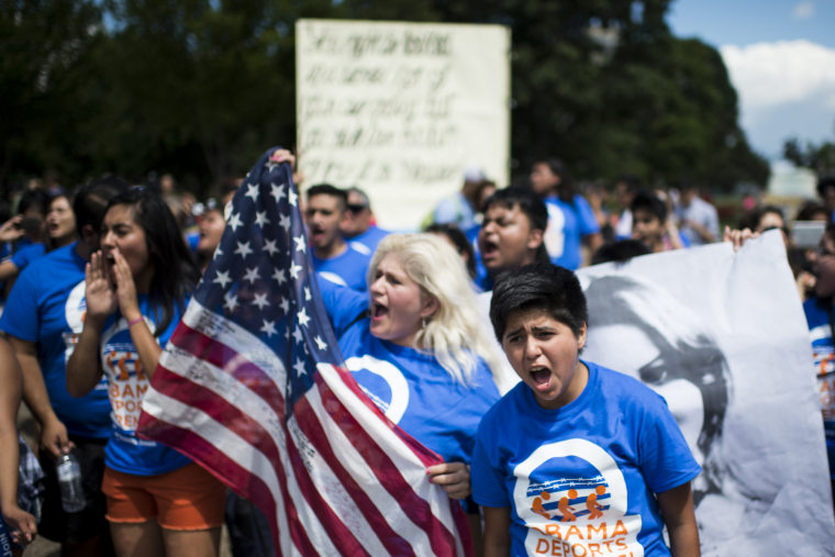 Immigration reform protesters with United We Dream chant in front of the White House to illustrate the stories of immigrant families on July 28, 2014. (Photo by Bill Clark/CQ Roll Call/Getty)