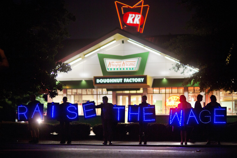 Fast food workers and supporters protest low wages outside a Krispy Kreme store, May 15, 2014, in Atlanta, Ga. (Photo by David Goldman/AP)