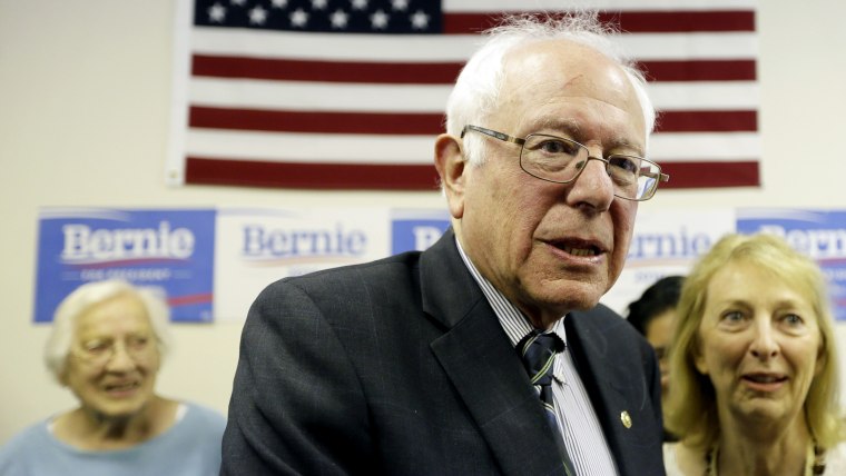 Democratic presidential candidate Sen. Bernie Sanders speaks with supporters during an open house at his Iowa campaign headquarters, June 13, 2015, in Des Moines, Ia. (Photo by Charlie Neibergall/AP)