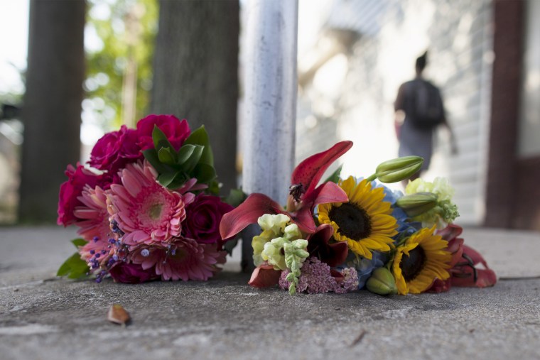 Flowers for the victims of Wednesday's shootings, are laid near a police barricade in Charleston, S.C., June 18, 2015, while police continue the search for suspected gunman, Dylann Roof. (Photo by Randall Hill/Reuters)