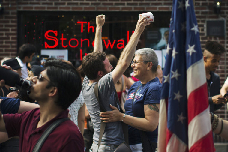 People embrace and cheer as they join a crowd celebrating the U.S. Supreme Court ruling against the Defense of Marriage Act outside the Stonewall Inn in N.Y. on June 26, 2013. (Photo by Lucas Jackson/Reuters)