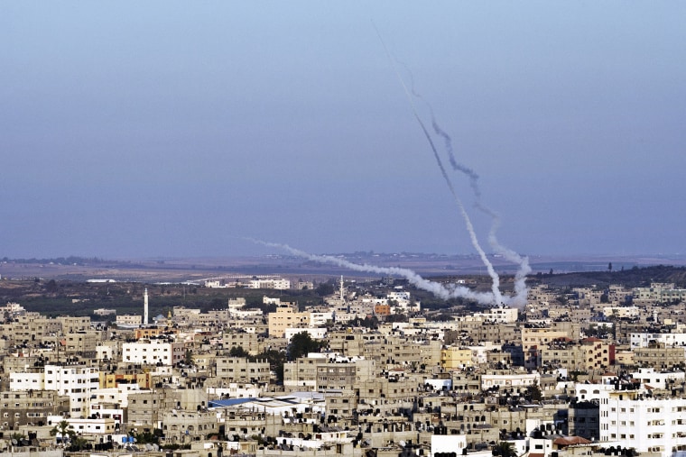 Smoke trails mark the path of Palestinian missiles fired from the north-east of Gaza City on Aug., 21, 2014. (Photo by Roberto Schmidt/AFP/Getty)