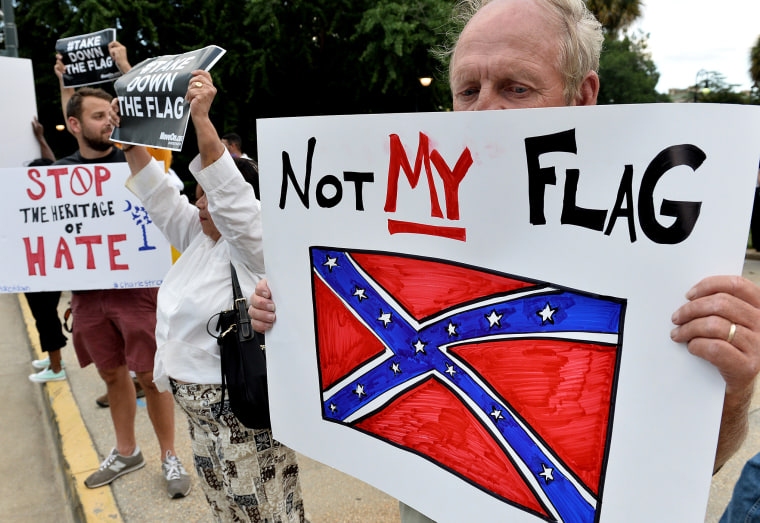 A man holds a sign up during a protest rally against the Confederate flag in Columbia, S.C., June 20, 2015. (Photo by Mladen Antonov/AFP/Getty)