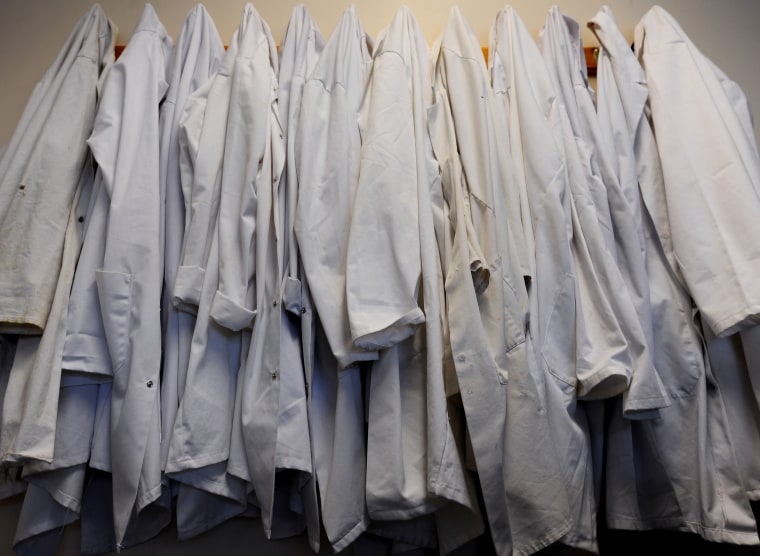 Laboratory coats hang up in a classroom, Jan. 27, 2015. (Photo by Lauren Hurley/PA Wire/AP)