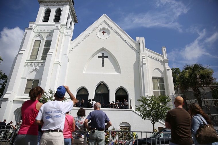 People look on as mourners file into the funeral of Cynthia Hurd, 54, at the Emanuel African Methodist Episcopal Church on June 27, 2015 in Charleston, S.C. (Photo by Joe Raedle/Getty)