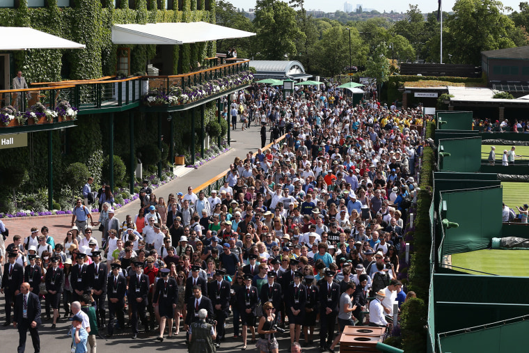Visitors are led in to the Wimbledon tennis tournament on June 29, 2015 in London, England.