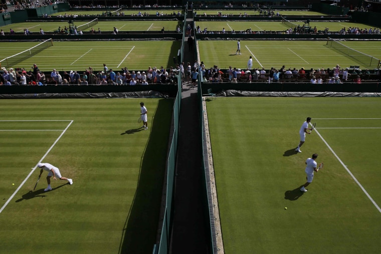 Players practice on the first day's play at the Wimbledon Tennis Championships in London, June 29, 2015. (Photo by Stefan Wermuth/Reuters)
