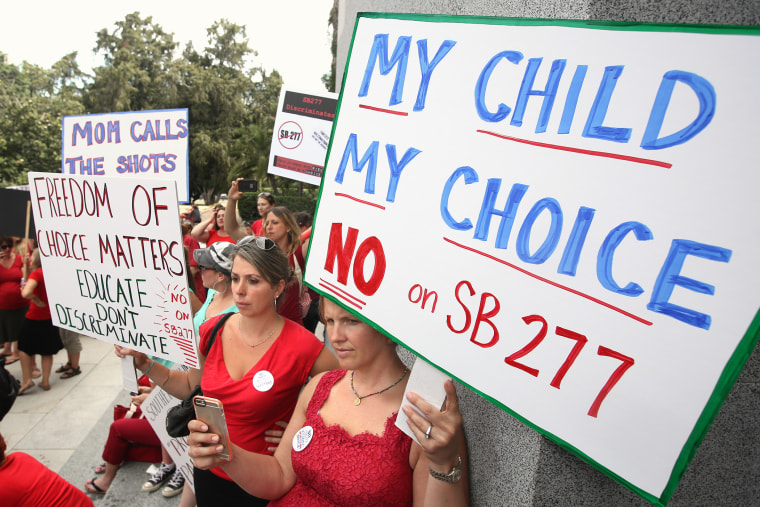 Karman Willmer, left, and Shelby Messenger protest against SB277, a measure requiring California schoolchildren to get vaccinated, at a Capitol rally, June 9, 2015, in Sacramento, Calif. (Photo by Rich Pedroncelli/AP)