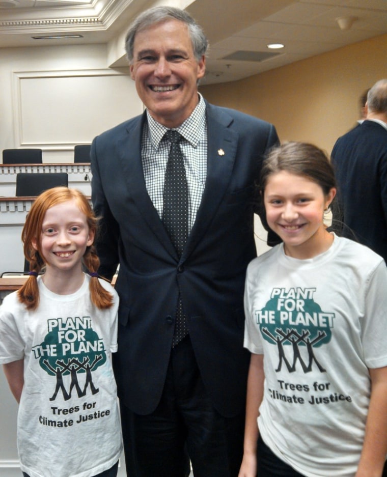 Zoe Foster (right) and Wren Wagenbach (left) pose with Washington State governor Jay Inslee after addressing his climate workgroup in 2013. (Courtesy of Our Children’s Trust)