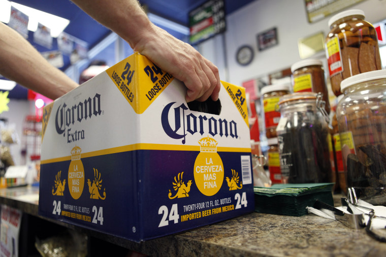 A customer places a case of beer on the checkout counter in Marysville, Pa. (Photo by Carolyn Kaster/AP).