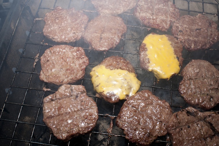 Cooking burgers and tailgating (Photo by Brian Finke/Gallery Stock).