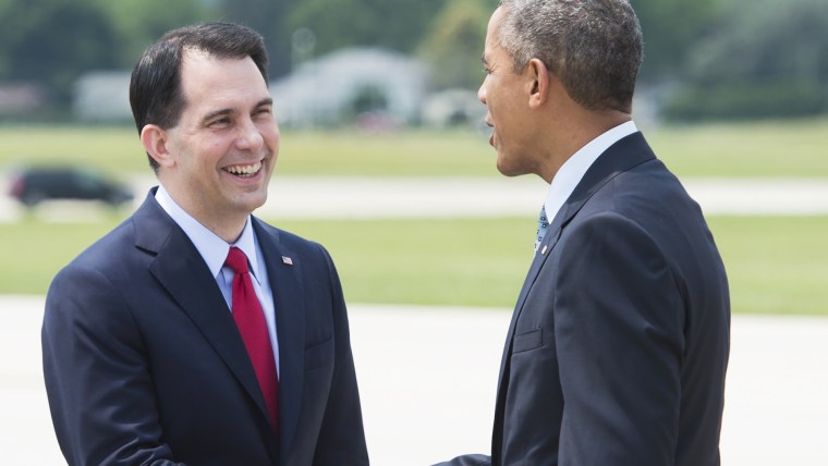 US President Barack Obama shakes hands with Wisconsin Republican Governor Scott Walker after arriving on Air Force One at La Crosse Regional Airport in La Crosse, Wis. on July 2, 2015. (Photo by Saul Loeb/AFP/Getty)