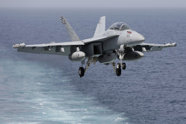 A U.S. military plane approaches to land on the flight deck of the USS Carl Vinson aircraft carrier in the Persian Gulf on March 19, 2015. (Photo by Hasan Jamali/AP)