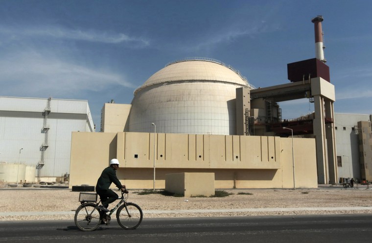 In this Oct. 26, 2010 file photo, a worker rides a bicycle in front of the reactor building of the Bushehr nuclear power plant, just outside the southern city of Bushehr.&nbsp;