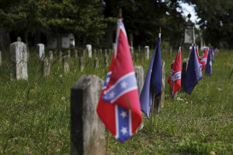 Confederate battle flags mark the graves of soldiers in the Confederate States Army in the U.S. Civil War in Magnolia Cemetery in Charleston