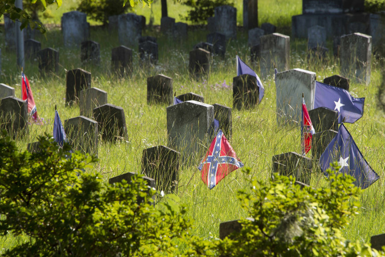 Confederate flags stand next to the headstone's of Confederate States of America (CSA) soldiers at the Magnolia Cemetery in Charleston, S.C., June 26, 2015. (Photo by Jim Watson/AFP/Getty)