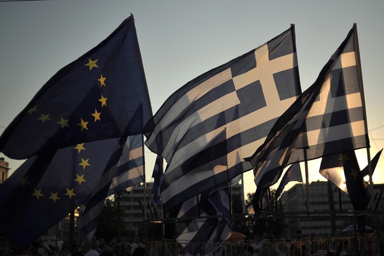 European Union and Greek flags are seen in a vendor kiosk during a pro euro rally in front of the Greek Parliament in Athens Greece, July 9, 2015. (Photo by Fotis Plegas G./EPA)