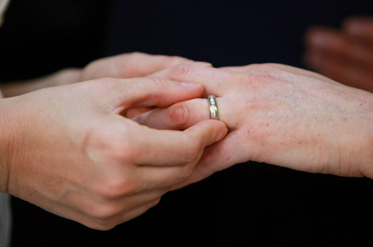 Same-sex couple exchange rings during their wedding ceremony (Photo by Justin Sullivan/Getty).