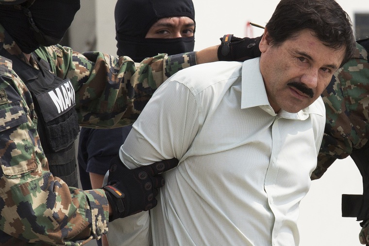 Drug trafficker Joaquin \"El Chapo\" Guzman is escorted to a helicopter by Mexican security forces at Mexico's International Airport in Mexico city, Mexico on Feb. 22, 2014. (Photo by Susana Gonzalez/Bloomberg/Getty)