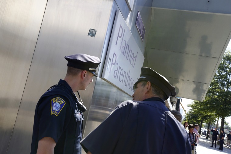 Boston police officers stand in front of a Planned Parenthood clinic in Boston