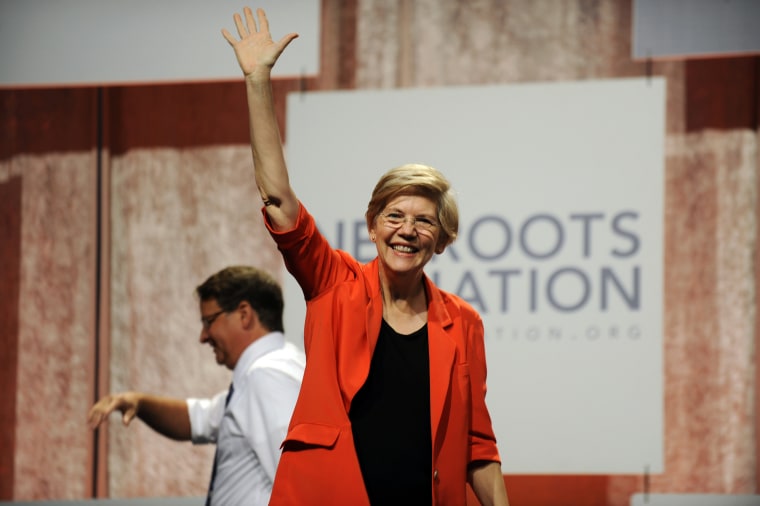 U.S. Sen. Elizabeth Warren, D-Mass., waves to the crowd after her introduction at the Netroots Nation conference in Detroit (Photo by David Coates/AP).
