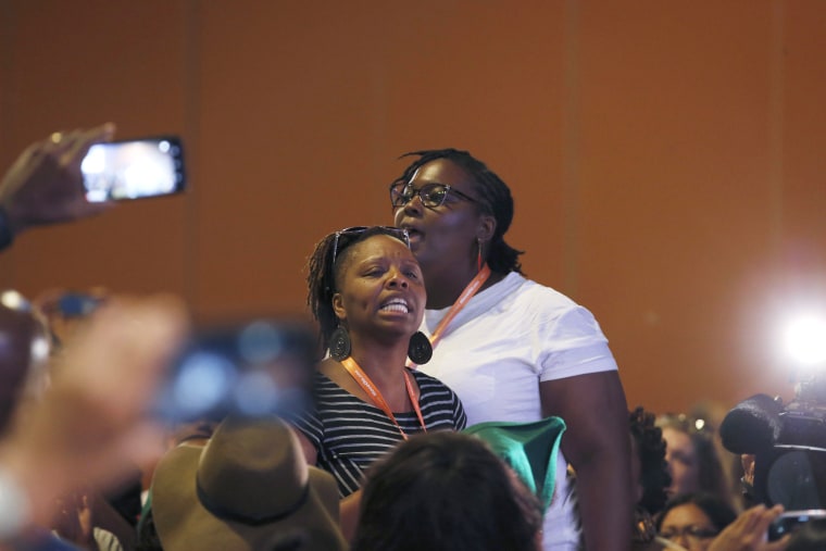 Black Lives Matter and Black Immigration Network activists shout down the first of two Democratic presidential candidates speakers at a Netroots Nation town hall meeting on July 18, 2015, in Phoenix, Ariz. (Photo by Ross D. Franklin/AP)