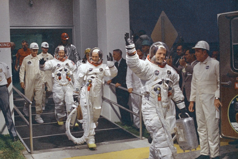 In this July 16, 1969 file photo, Neil Armstrong waving in front, heads for the van that will take the crew to the rocket for launch to the moon at Kennedy Space Center in Merritt Island, Fla. (Photo by AP)