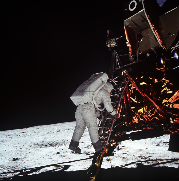 Astronaut Edwin E. Aldrin, Jr., lunar module pilot, descends the steps of the Lunar Module ladder July 20, 1969 as he prepares to walk on the Moon.